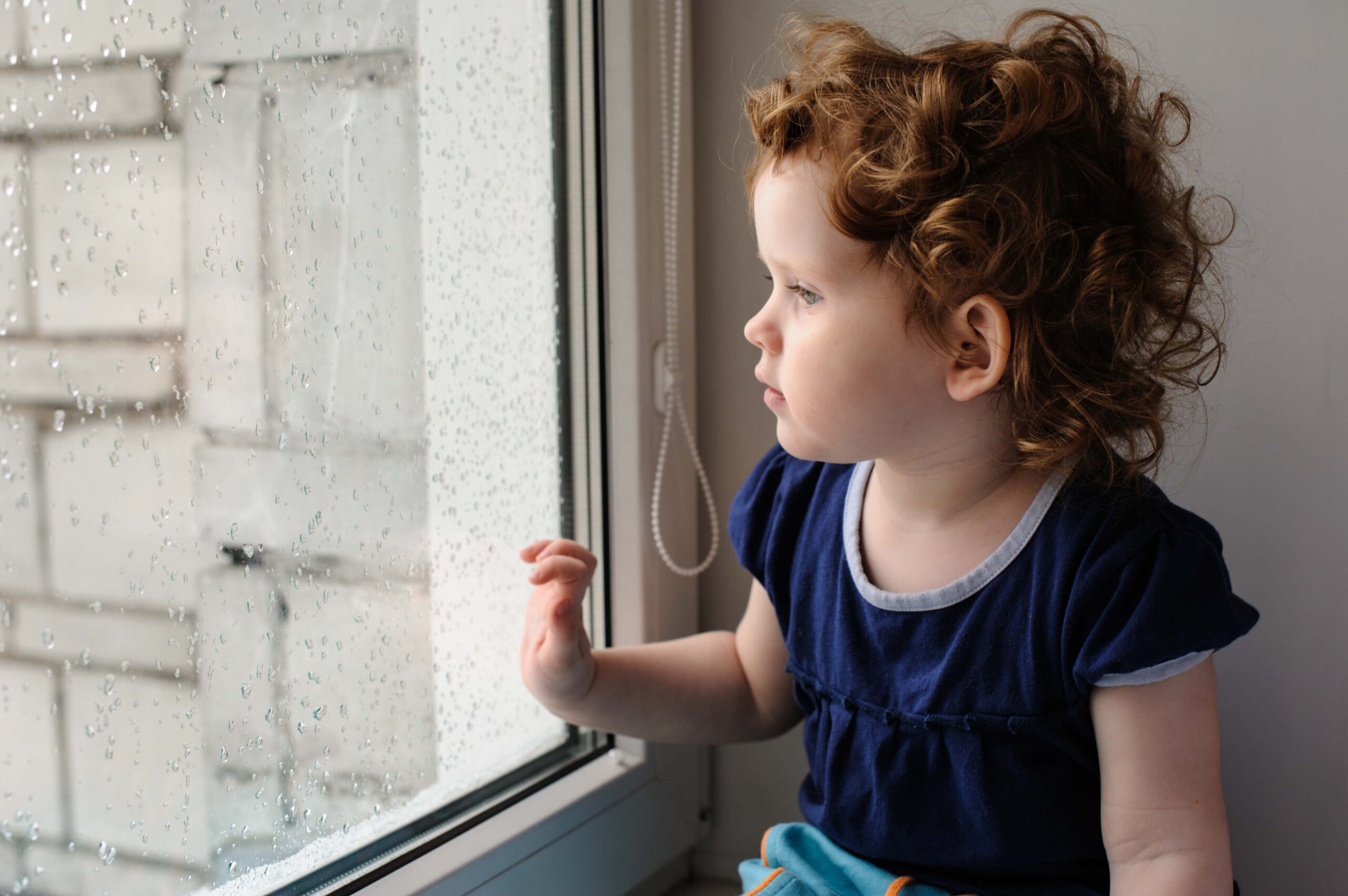 Home 6 window cords with child at window scaled