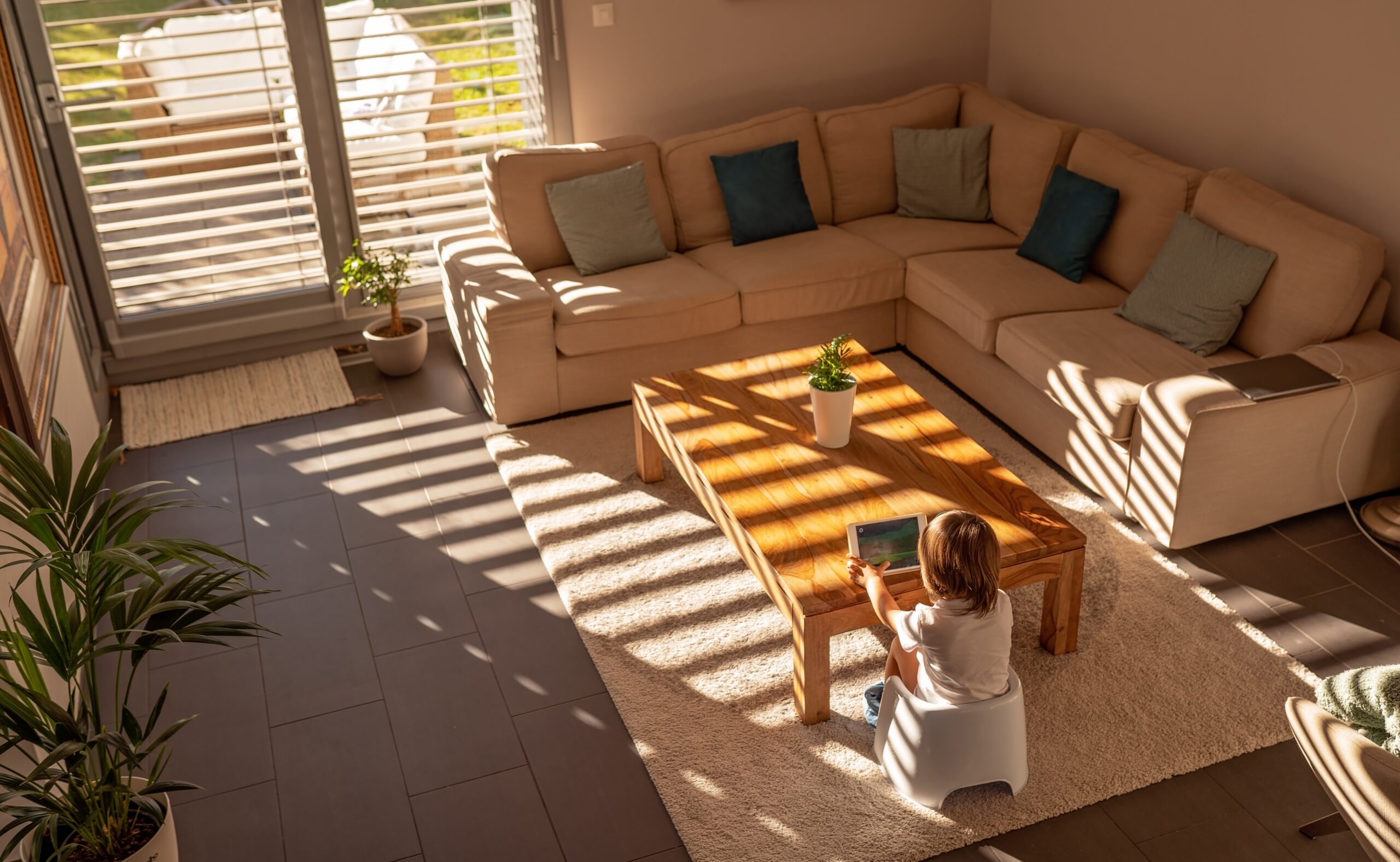 child on tablet enjoying winter sun scaled